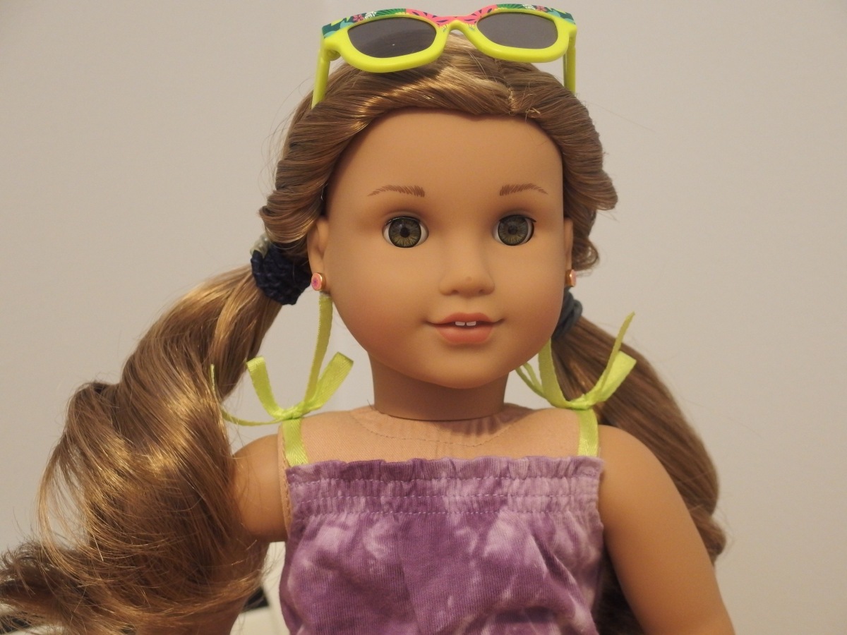 Avia with exclusive sunglasses, wearing exclusive dress, hair is in twisty pigtails
